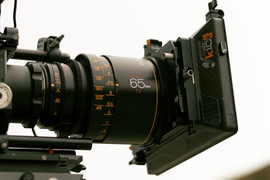 Close-up of a broadcast camera lens and viewfinder monitor
